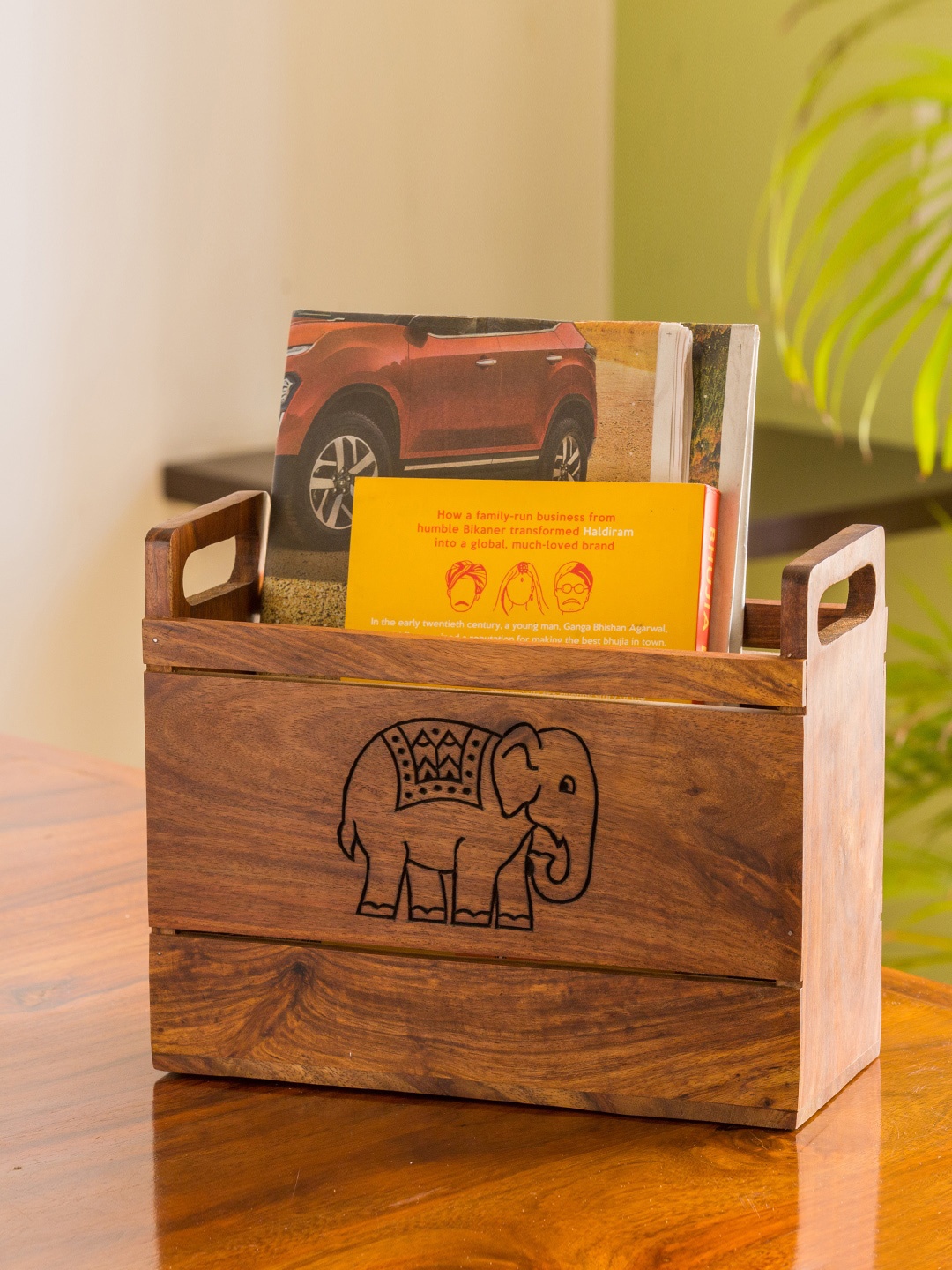 

ExclusiveLane Brown Handcarved The Elephant Warriors Sheesham Wood Table Magazine Stand