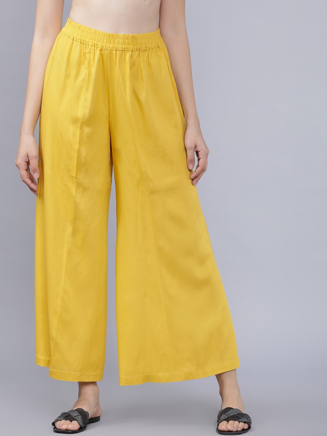 

Vishudh Women Yellow Solid Flared Palazzos