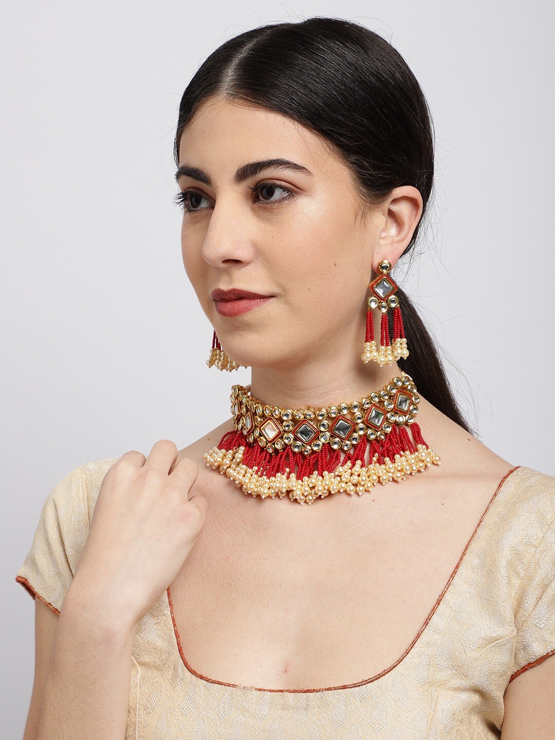 

Sukkhi Gold-Plated Red & Beige Kundan-Studded Beaded Enamelled Jewellery Set
