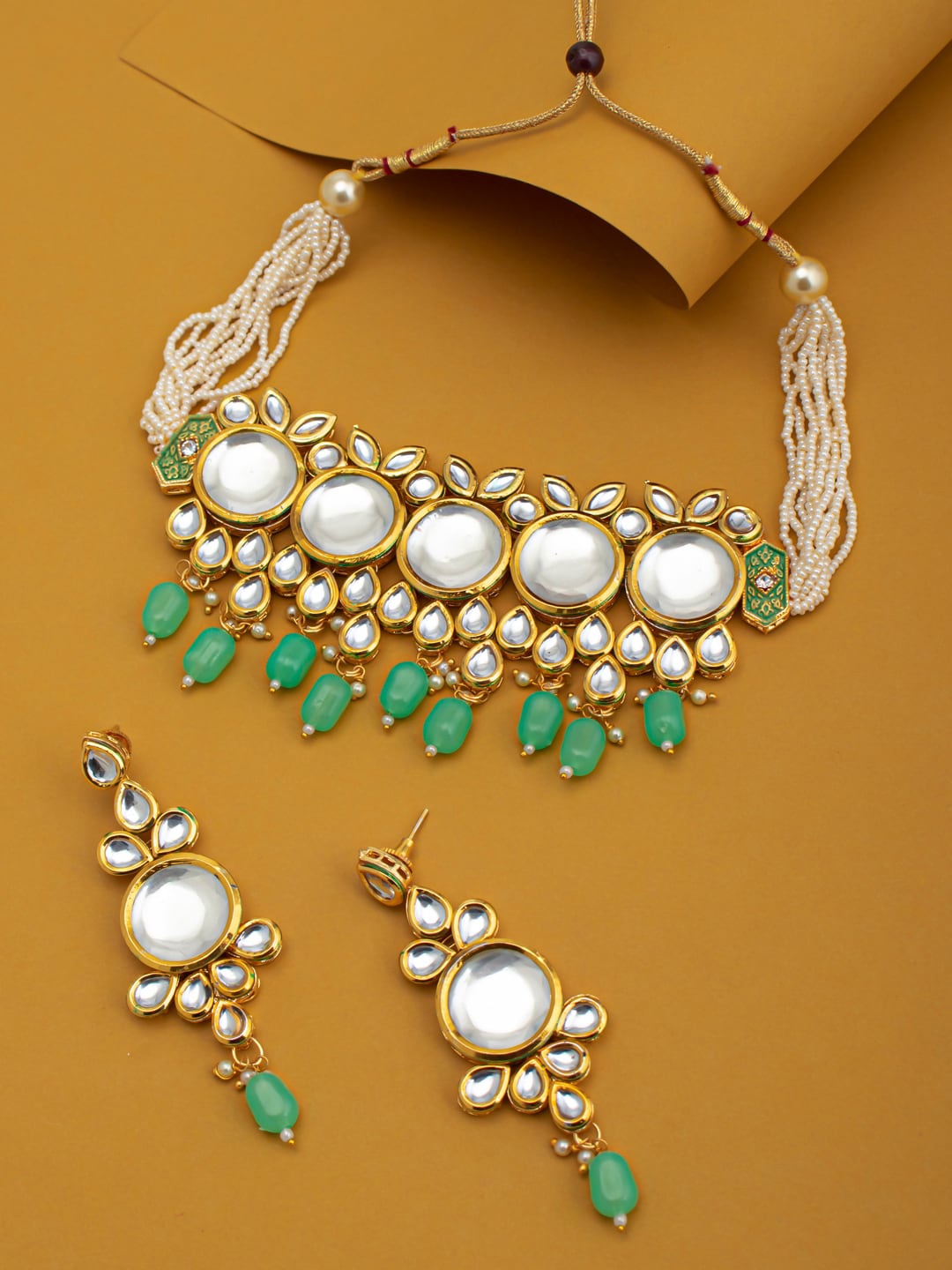 

Sukkhi Gold Plated White & Green Kundan-Studded Beaded Sustainable Jewellery Set