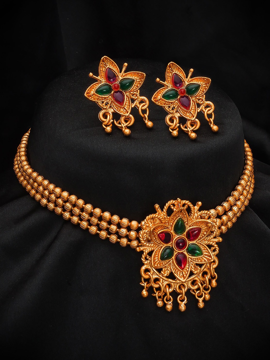

aadita Gold-Plated Red & Green Stone-Studded & Beaded Jewellery Set