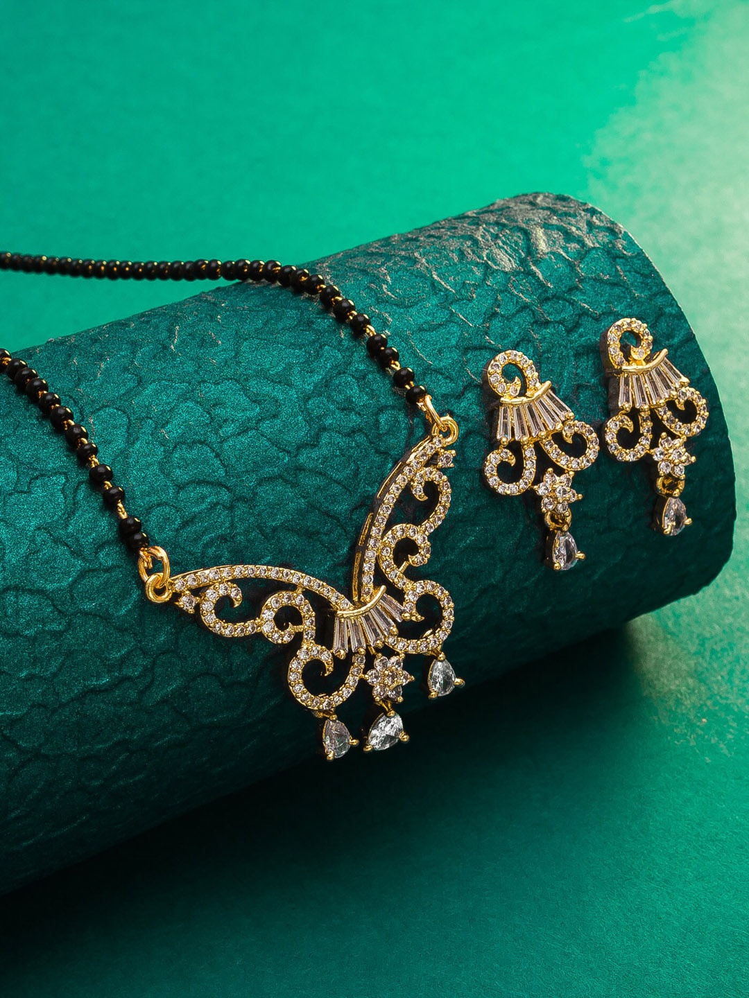 

aadita Gold-Plated Black & White AD-Studded & Beaded Mangalsutra With Earrings