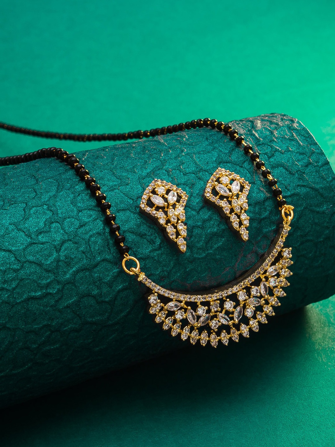 

aadita Gold-Plated Black & White AD-Studded & Beaded Mangalsutra With Earrings