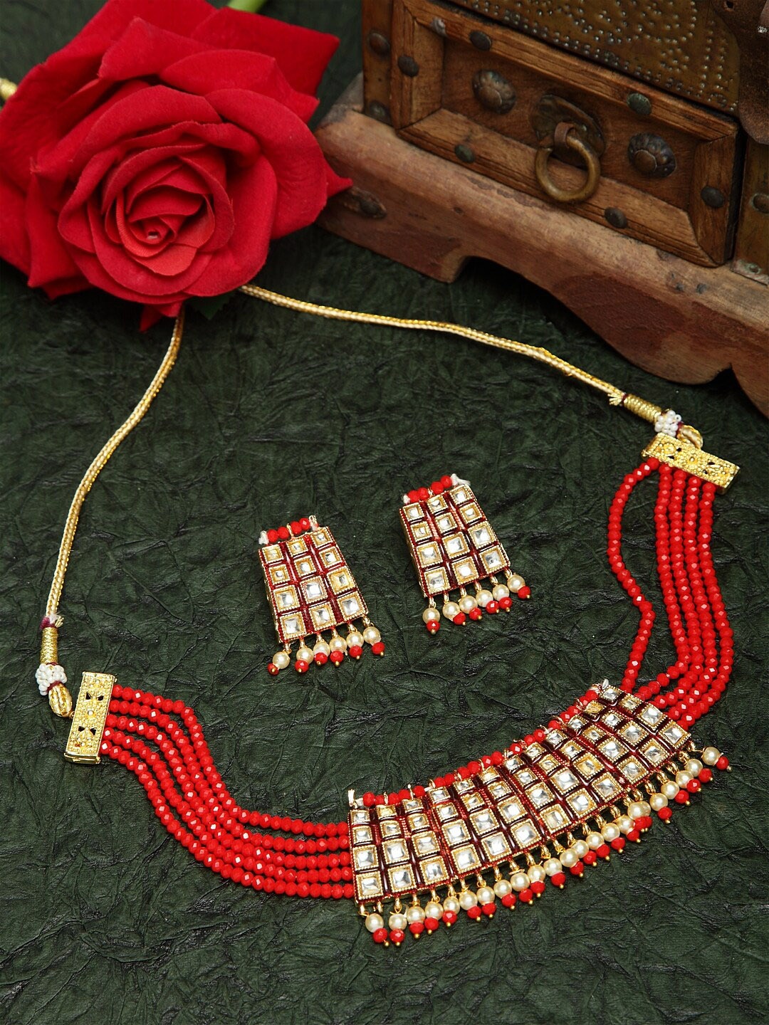 

Moedbuille Kundan Pearls and Red Onyx Stones Studded Gold Plated Handcrafted Jewelry Set