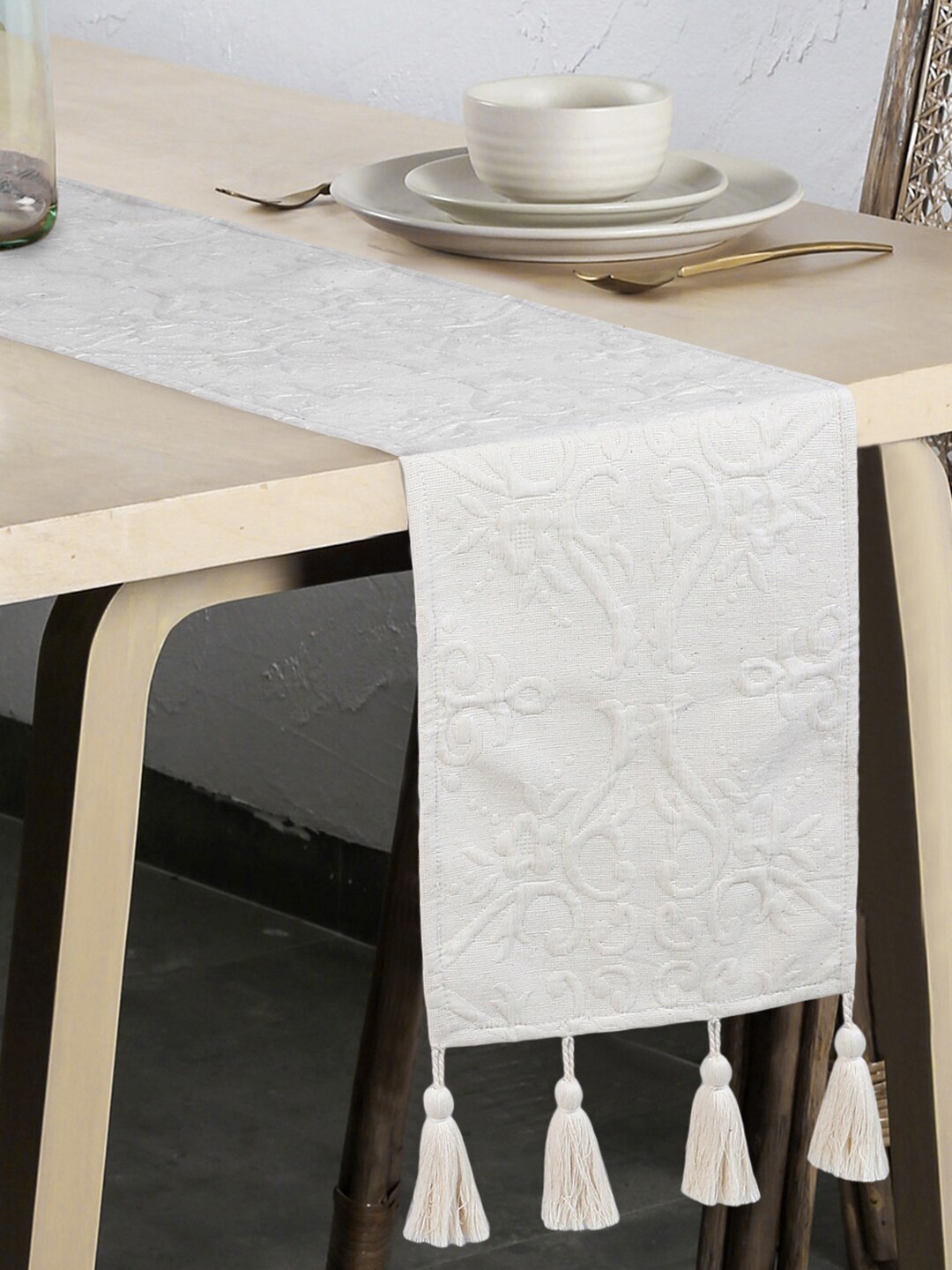 

Mezposh Off White Ethnic Motifs Embroidered 6- Seater Table Runner with Tassels