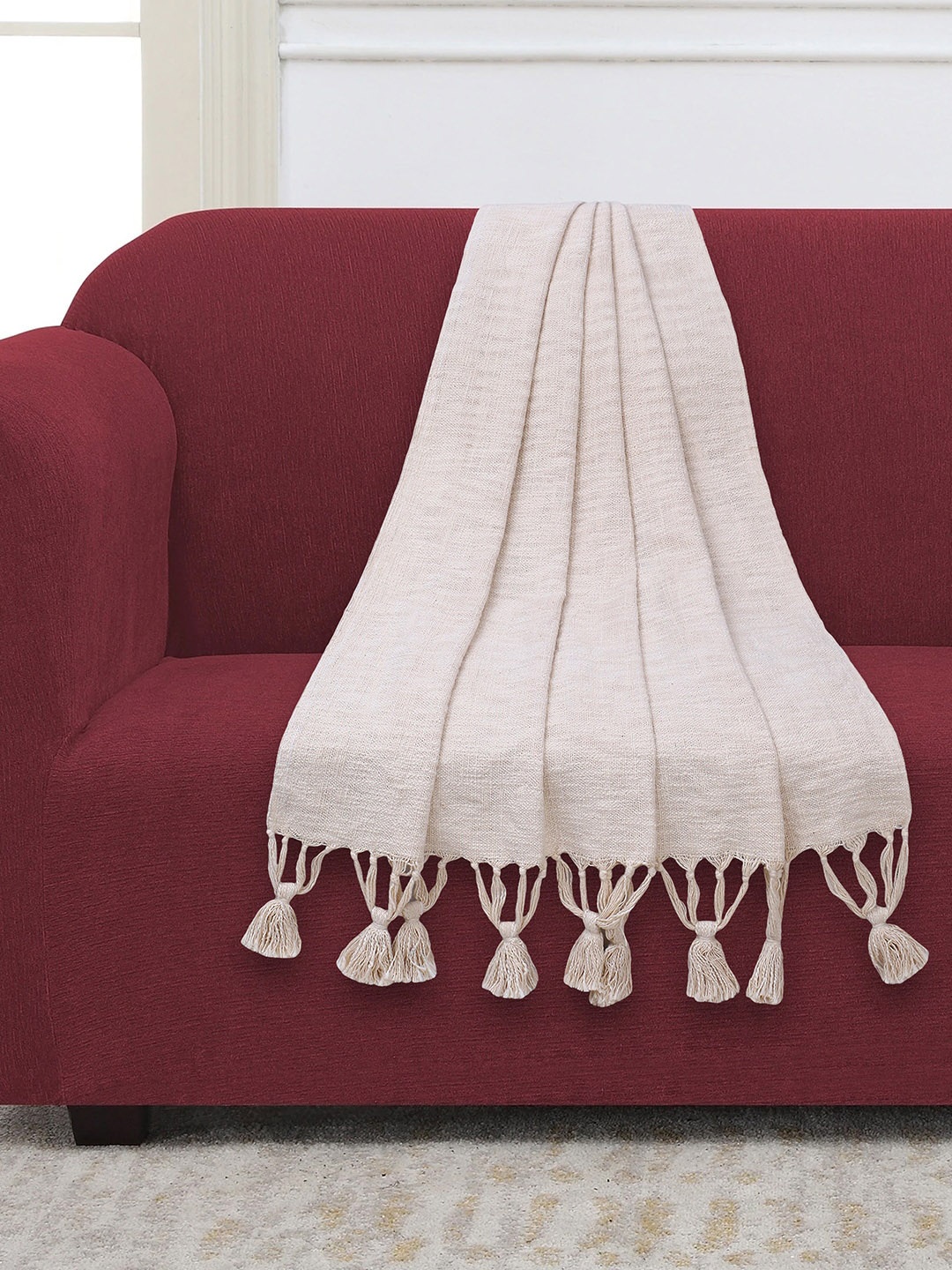 Mezposh Off White Self-Design Tasselled Sofa Throw