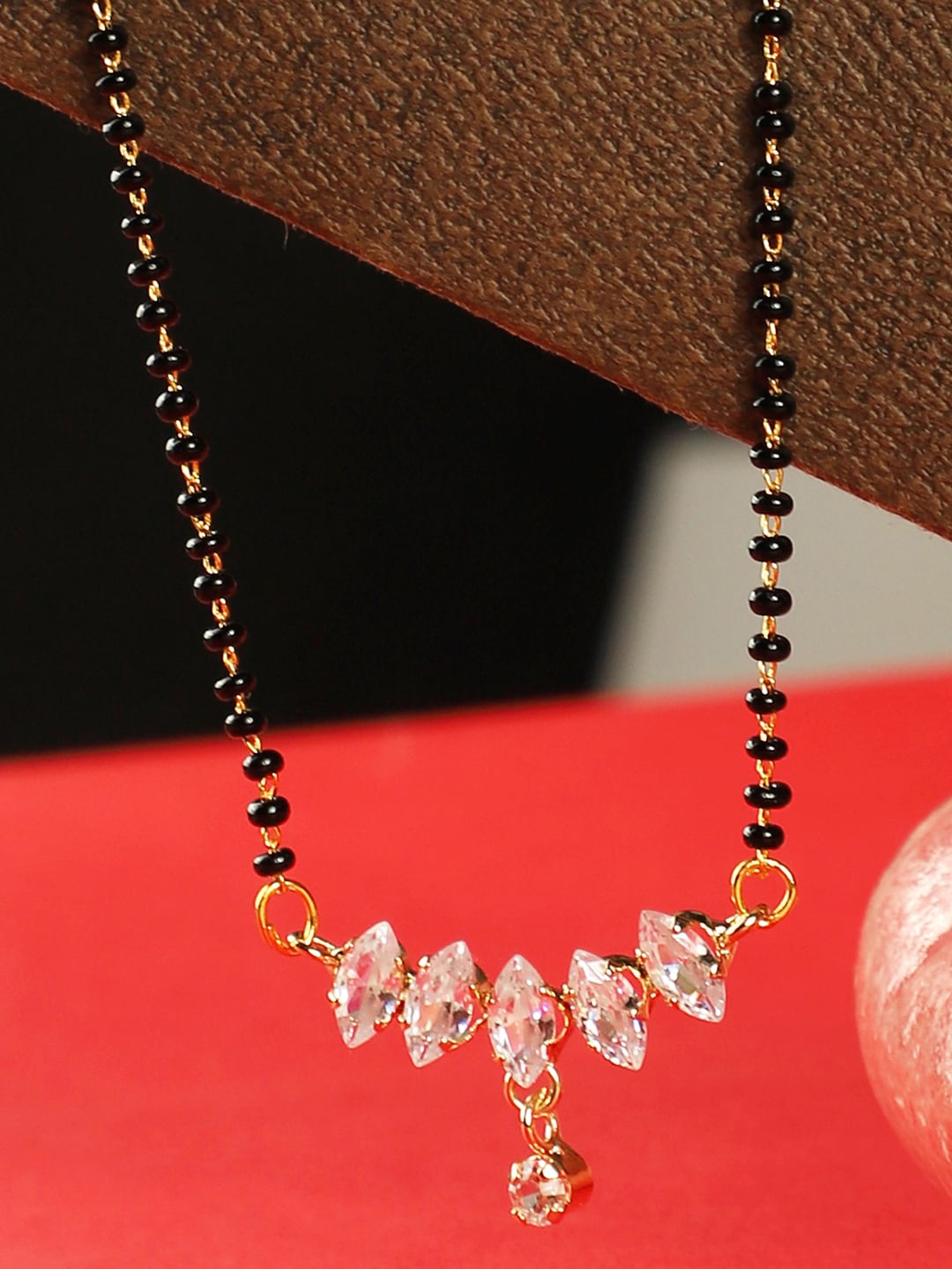 

ANIKAS CREATION Gold-Plated Black & White Stone-Studded & Beaded Mangalsutra