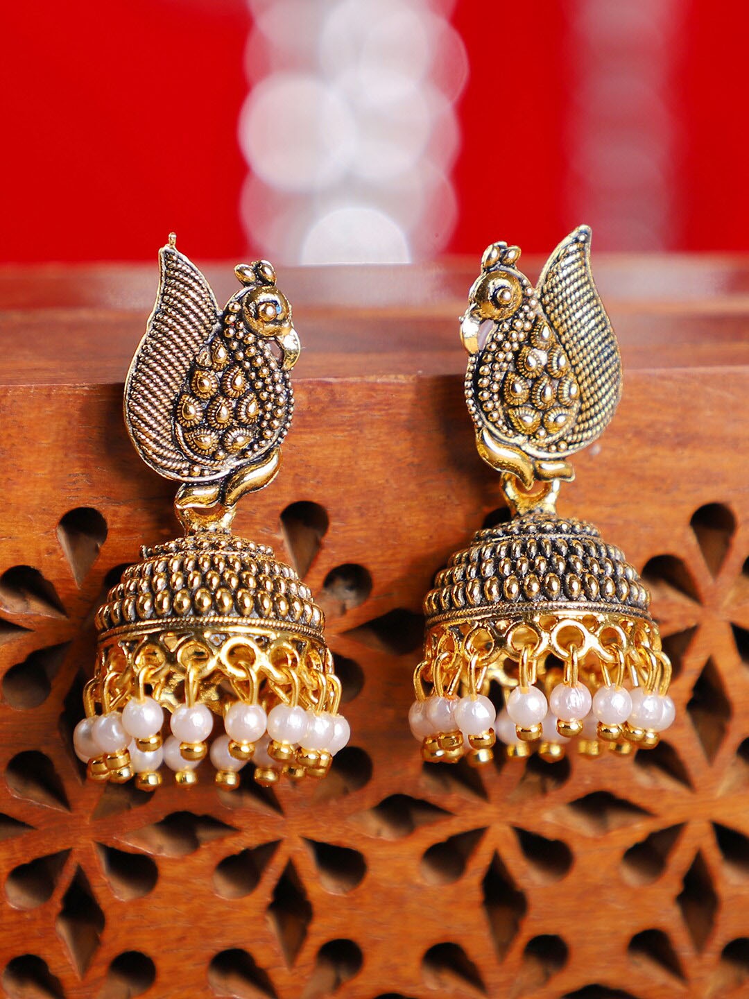 

ANIKAS CREATION Gold-Toned Peacock Shaped Jhumkas