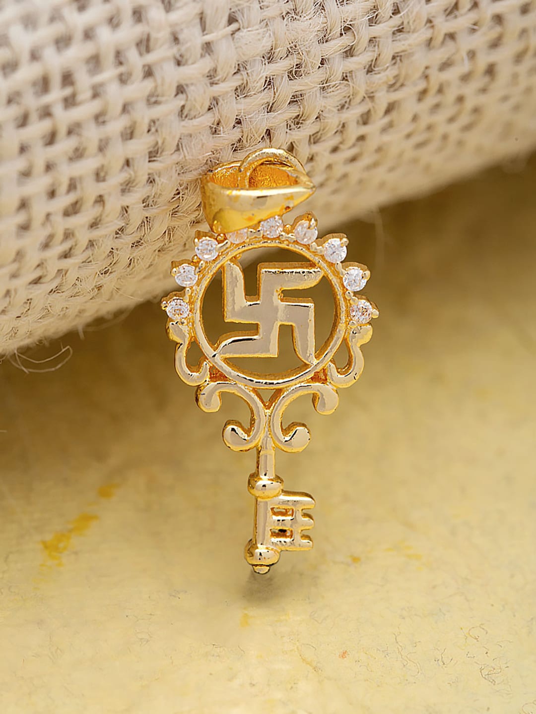 

Dare by Voylla Gold-Toned Silver-Coloured Cubic Zirconia Key Shape Spiritual Saga Swastika Pendant