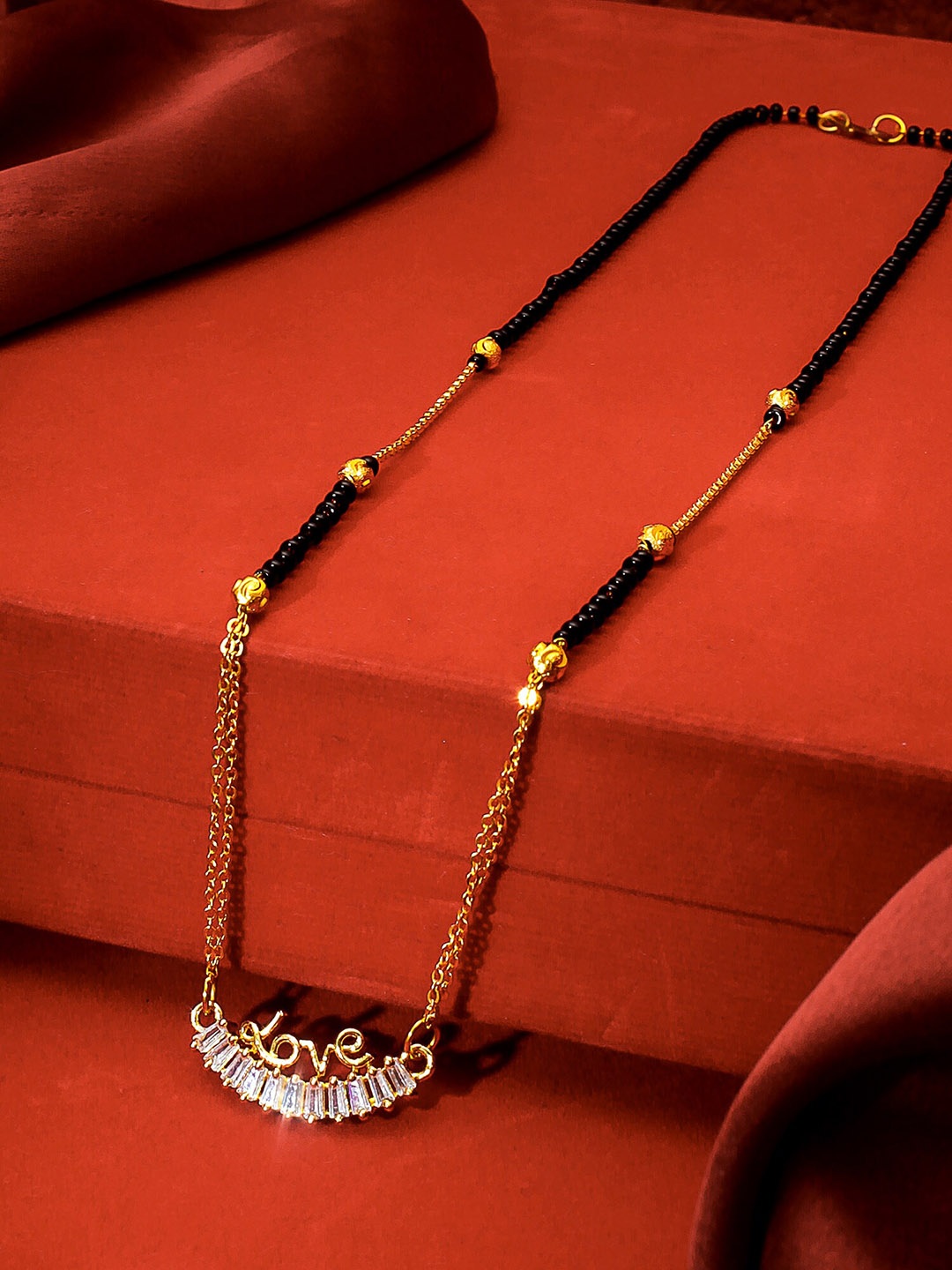 

aadita Gold-Plated Black & White AD-Studded & Beaded Mangalsutra