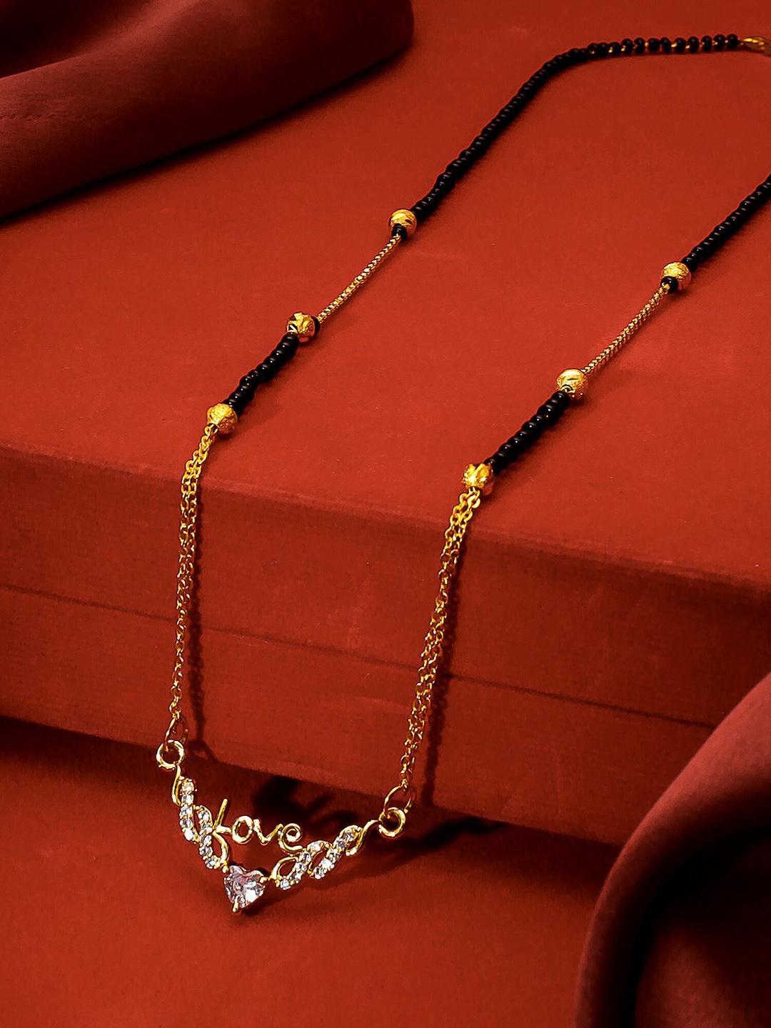 

aadita Gold-Plated Black & White AD-Studded & Beaded Mangalsutra
