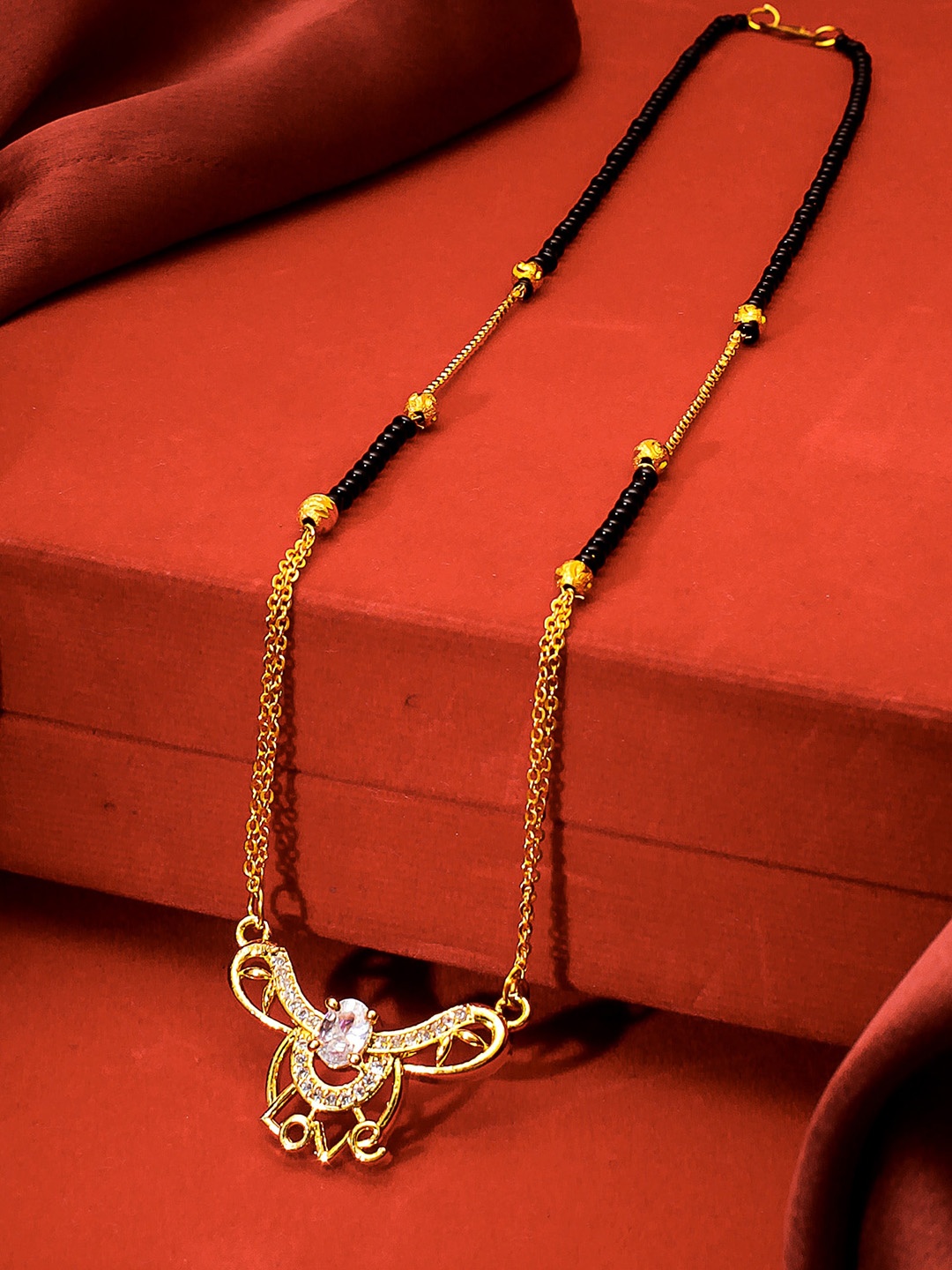 

aadita Gold-Plated Black & White American Diamond Studded & Beaded Mangalsutra