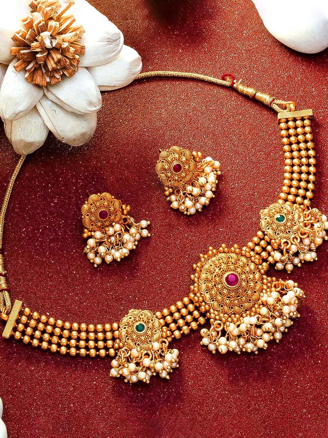 

aadita Gold-Toned & Green Stone-Studded & Beaded Jewellery Set