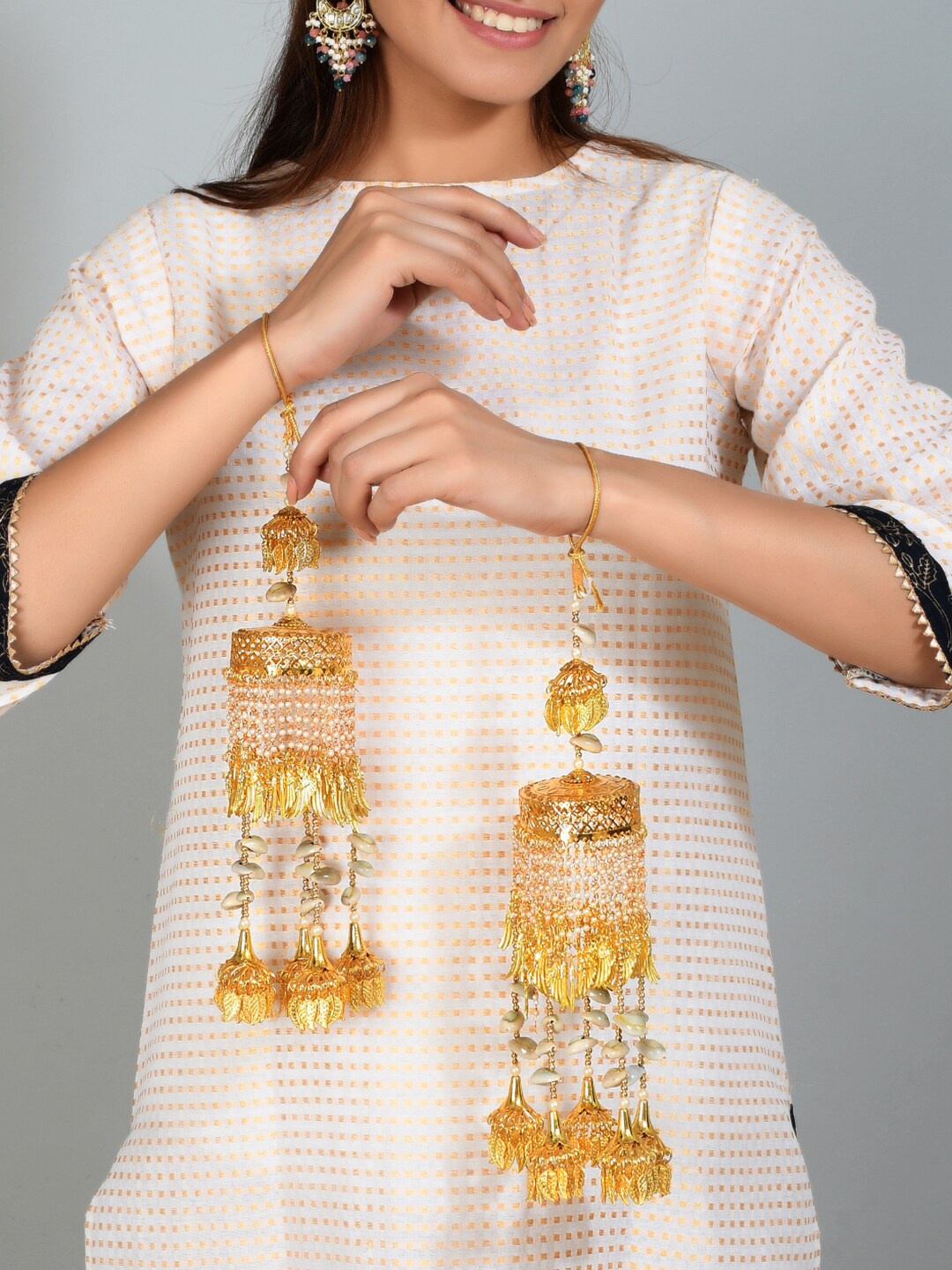 

Silvermerc Designs Set Of 2 Gold-Plated Pearl Ghungroo And Sea Shell Kodi Heavy Punjabi Bridal Kaleeras