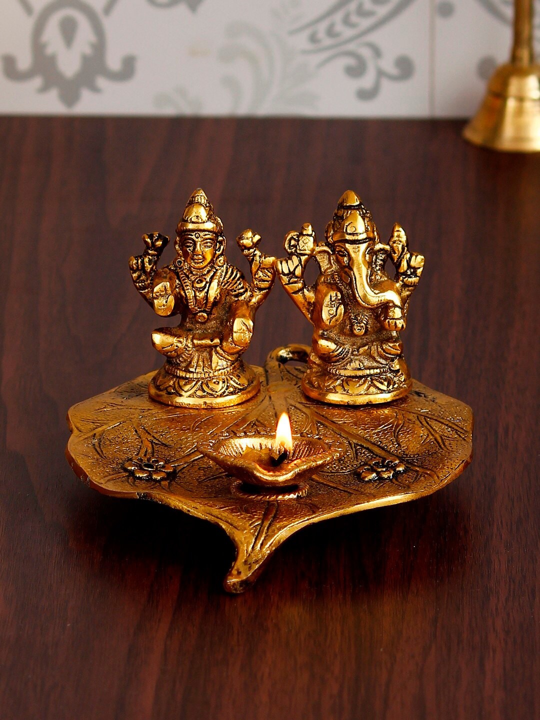 

eCraftIndia Antique Gold-Toned Metal Handcrafted Laxmi Ganesh With Diya On Leaf