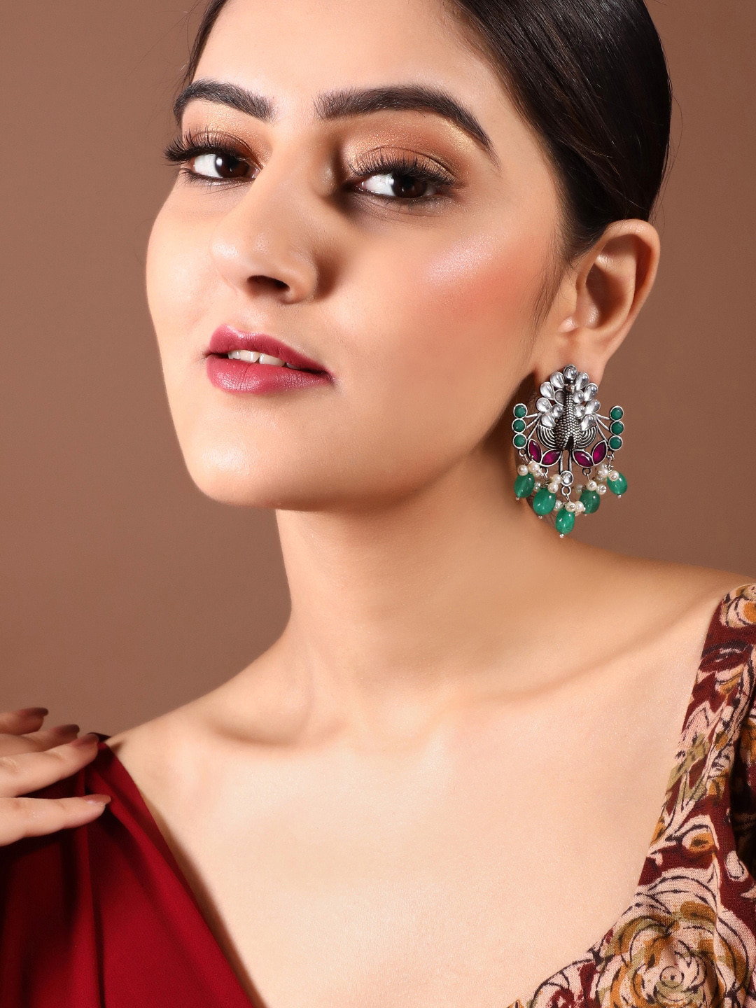 

Rubans Oxidised Silver-Plated Kundan with Ruby Studded Peacock Shaped Earrings
