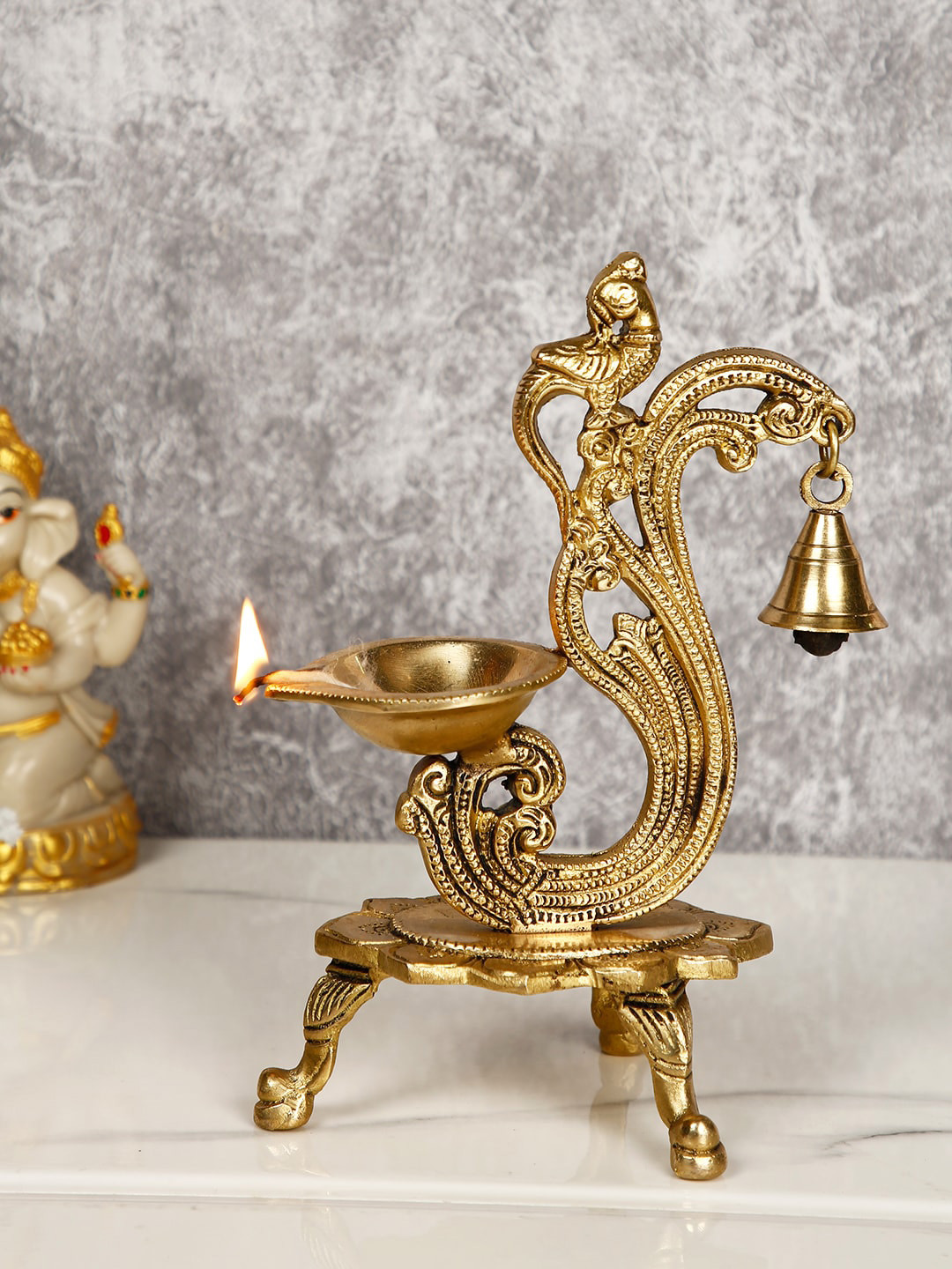 

CraftVatika Gold-Toned Brass Handmade Decorative Peacock Design Diya with Bell & Stand