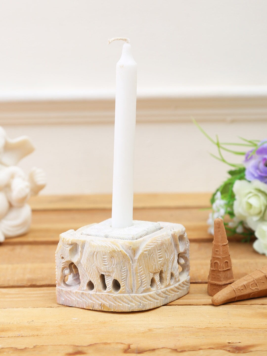 

Aapno Rajasthan Beige Carved Elephant Candle Stand