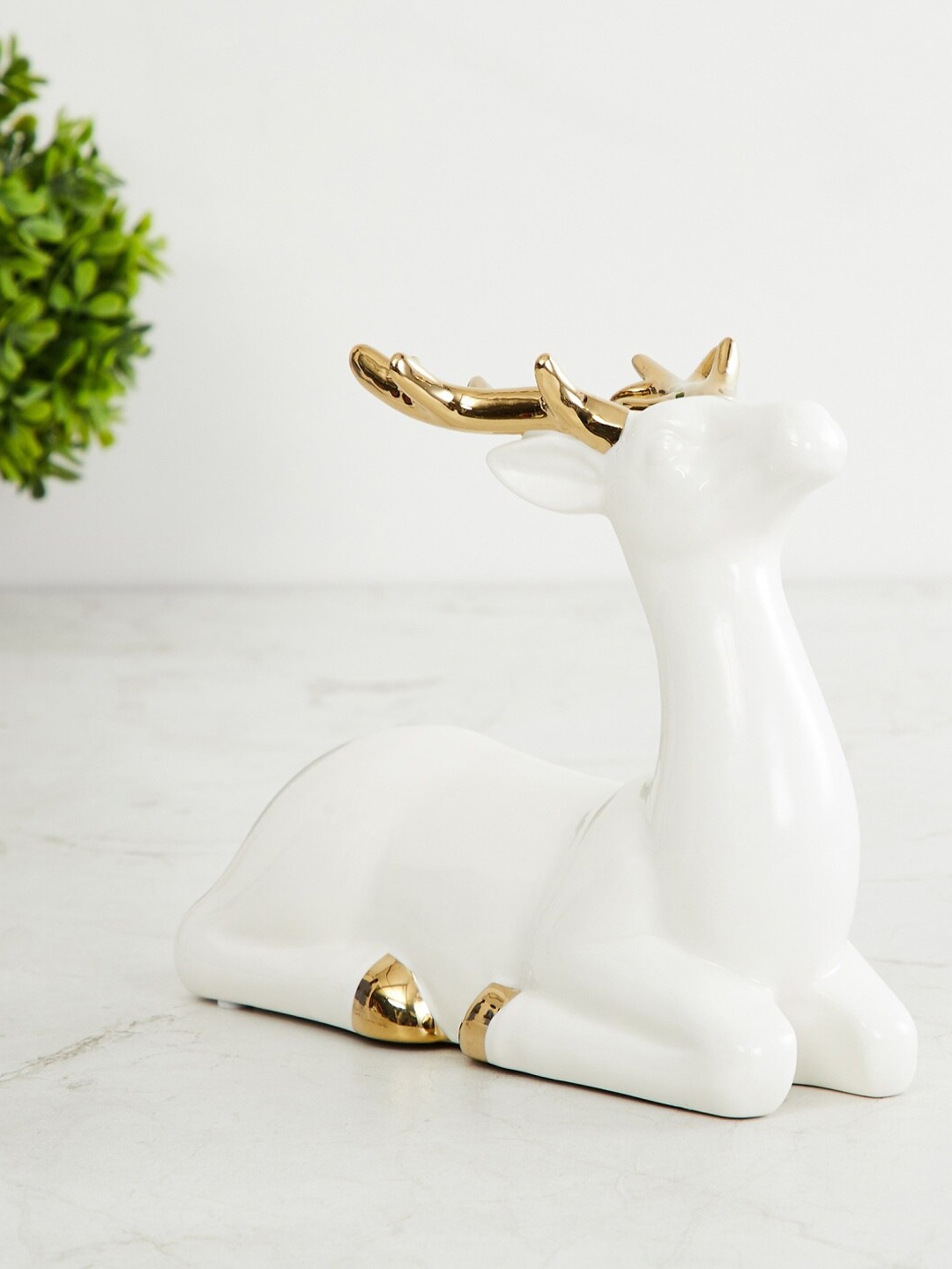 

Home Centre White & Gold-Toned Ceramic Brighton Sitting Reindeer Figurine Showpiece