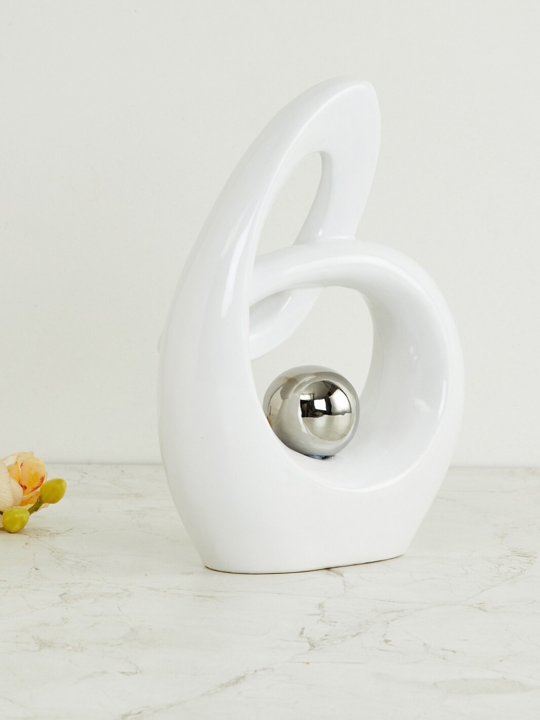 

Home Centre White & Silver-Toned Solid Vitara Abstract Figurine Showpiece