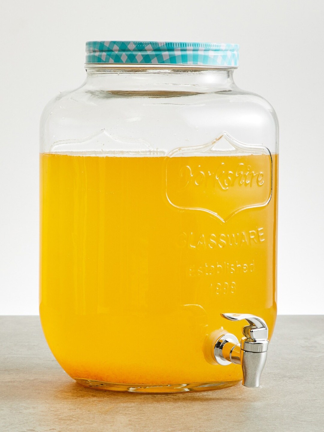 

Home Centre Transparent & Sky Blue Solid Glass Peroni-Cuba Jar with Tap 8000 ml