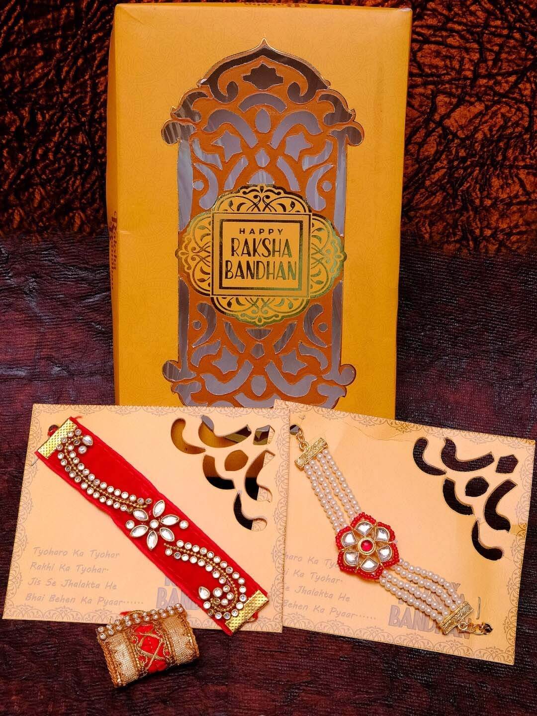 

Crunchy Fashion Bracelet Material Moti and Threads Red Kundan Rakhi Combo Set, Gold