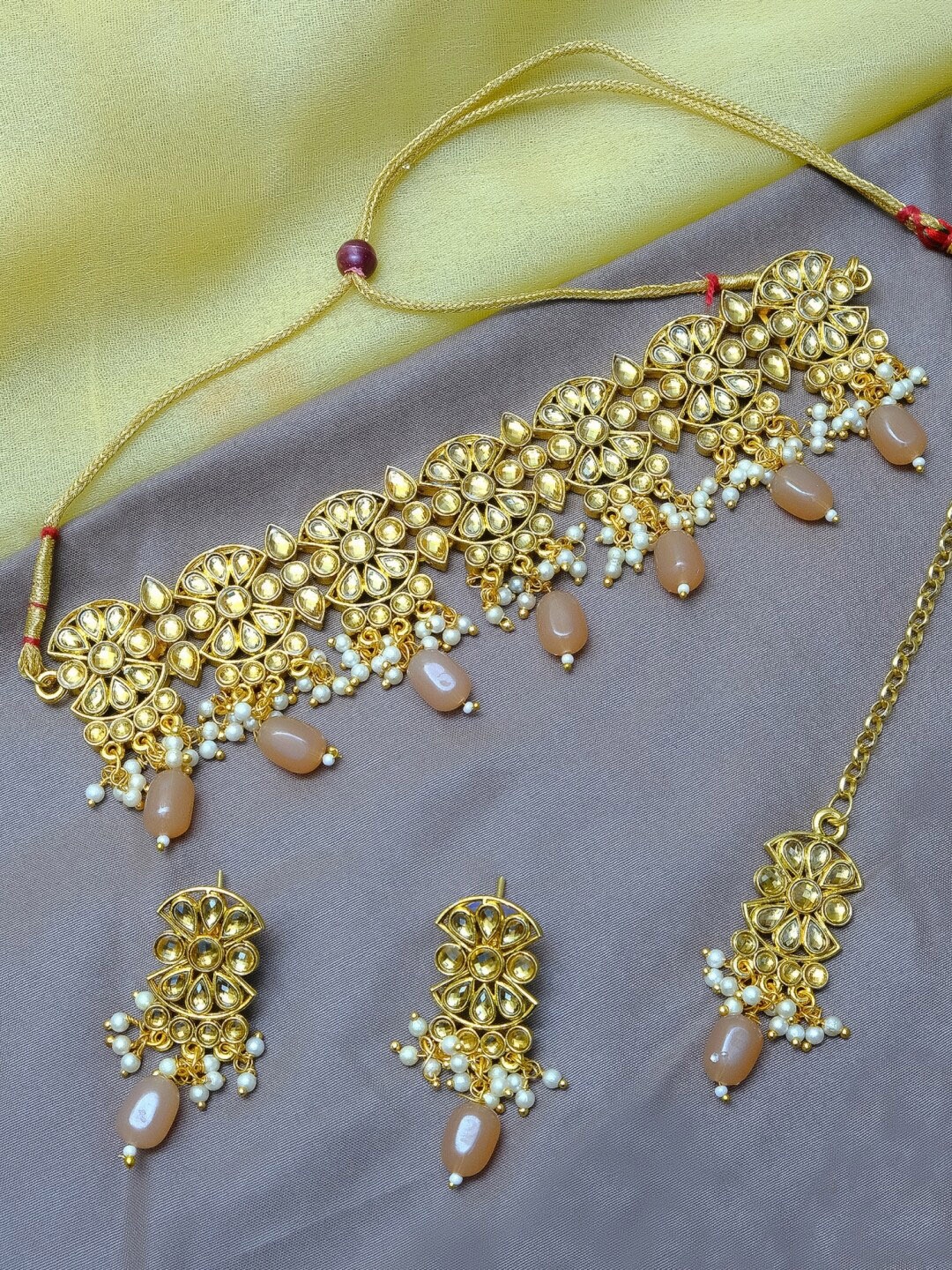

Crunchy Fashion Gold-Plated & Beige Stone-Studded & Beaded Antique Jewellery Set