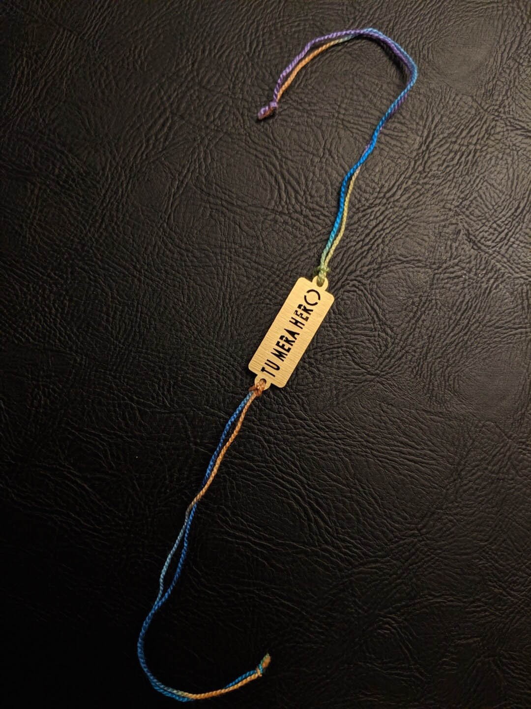 

Digital Dress Room Gold-Toned Rakhi Design with Tu Mera Hero Funky Slogan