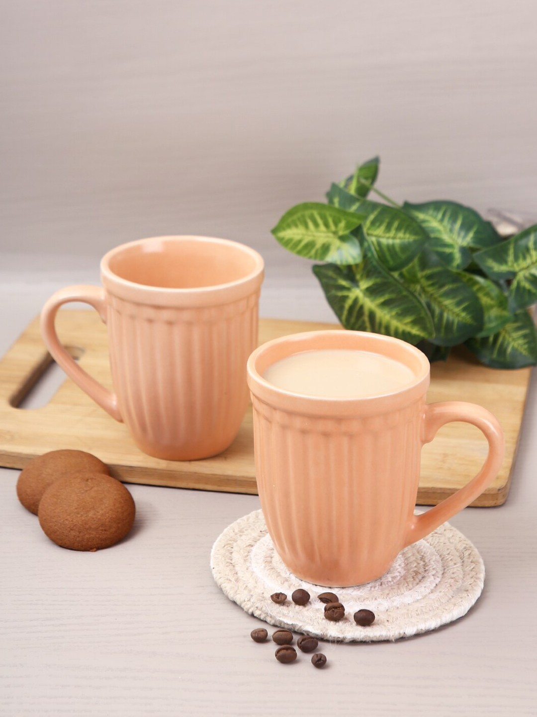 

Aapno Rajasthan Set Of 2 Peach-Coloured Textured Ceramic Glossy Coffee Mugs