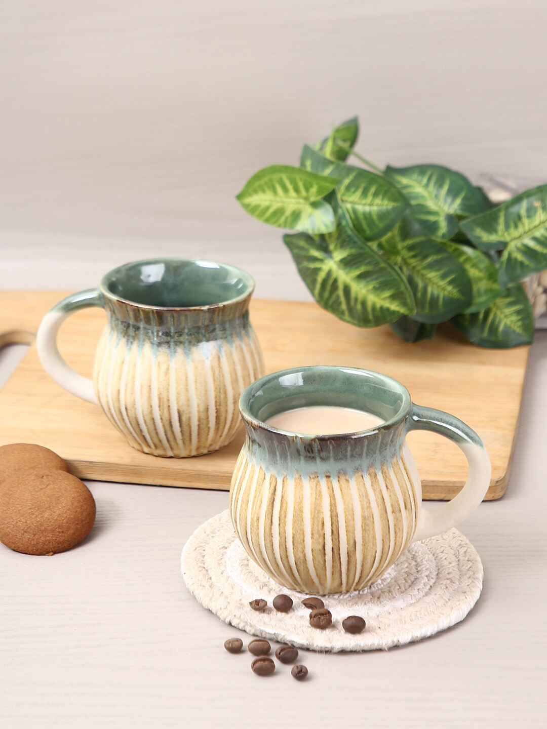

Aapno Rajasthan Set Of 4 Beige & Green Textured Ceramic Glossy Coffee Mugs