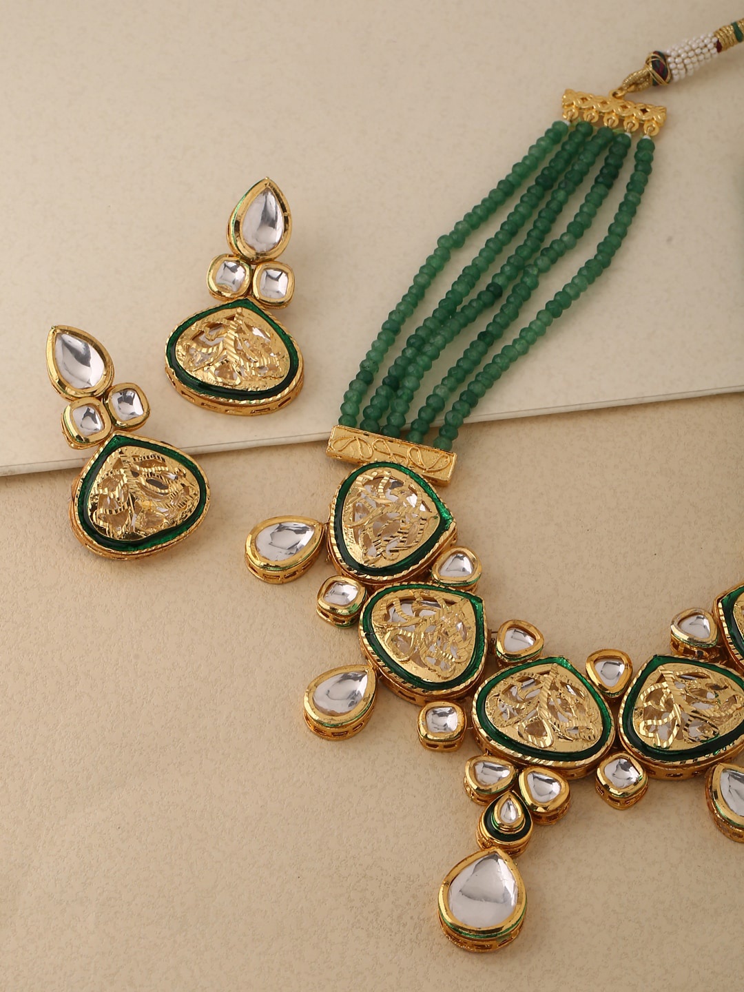 

Shoshaa Women Gold-Plated White & Green Stone-Studded Handcrafted Jewellery Set