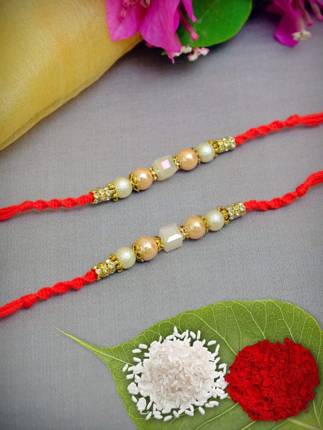 

Crunchy Fashion Red & Cream Set of 2 Rakhi With Chawal Tilak