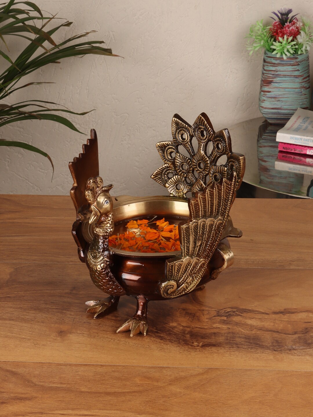 

Aapno Rajasthan Brown & Gold-Toned Brass Peacock Uruli Showpiece