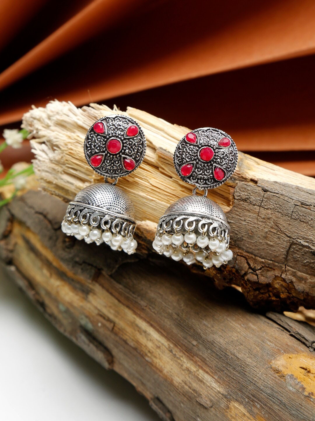 

NEUDIS Women Silver-Toned & Red Stone Studded Dome Shaped Jhumka Earring
