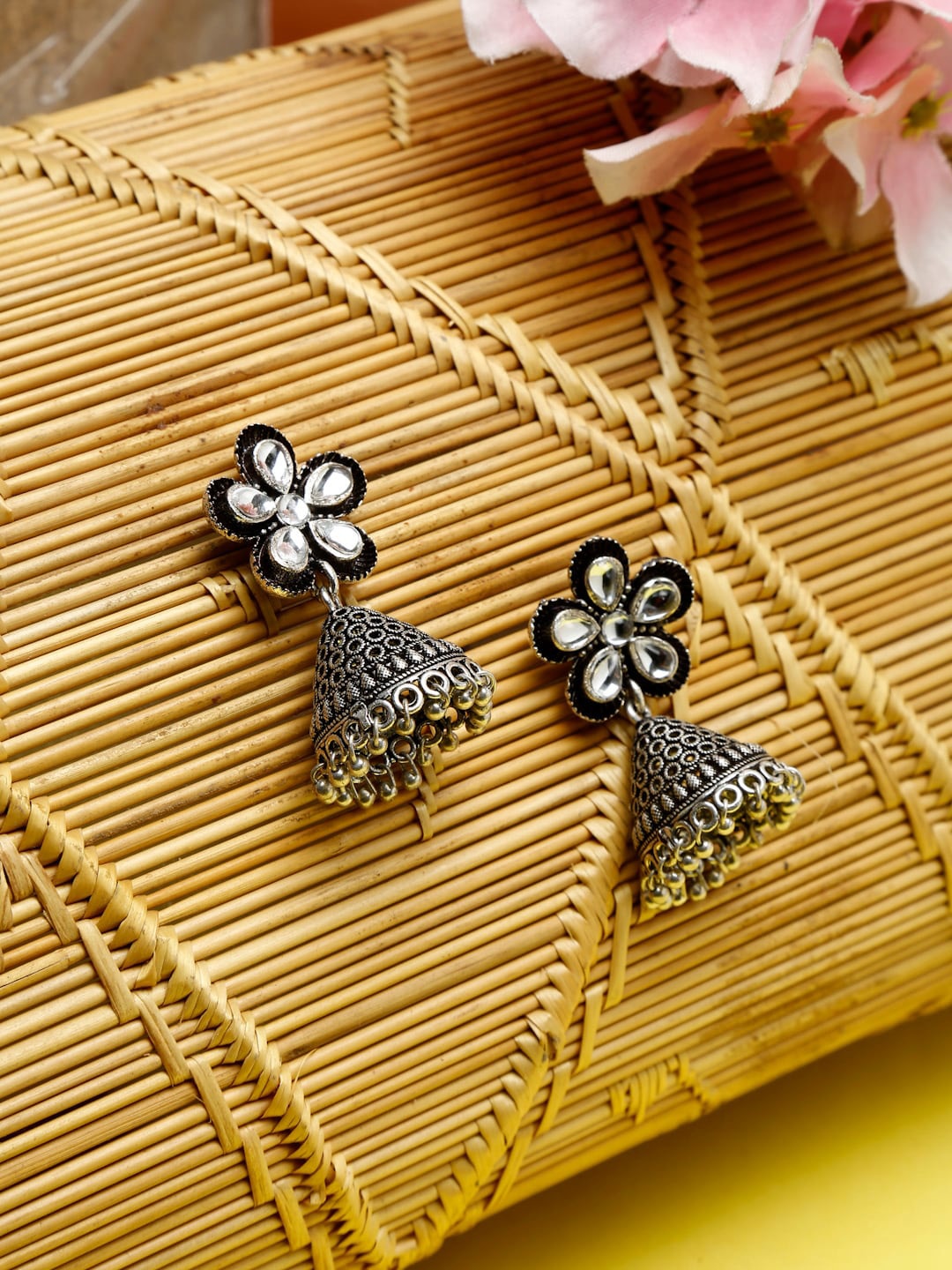 

NEUDIS Silver-Toned & Black Oxidised Floral Jhumkas Earrings