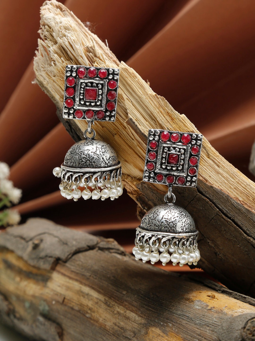 

NEUDIS Women Silver-Toned & Red Stone Classic Jhumkas Earrings