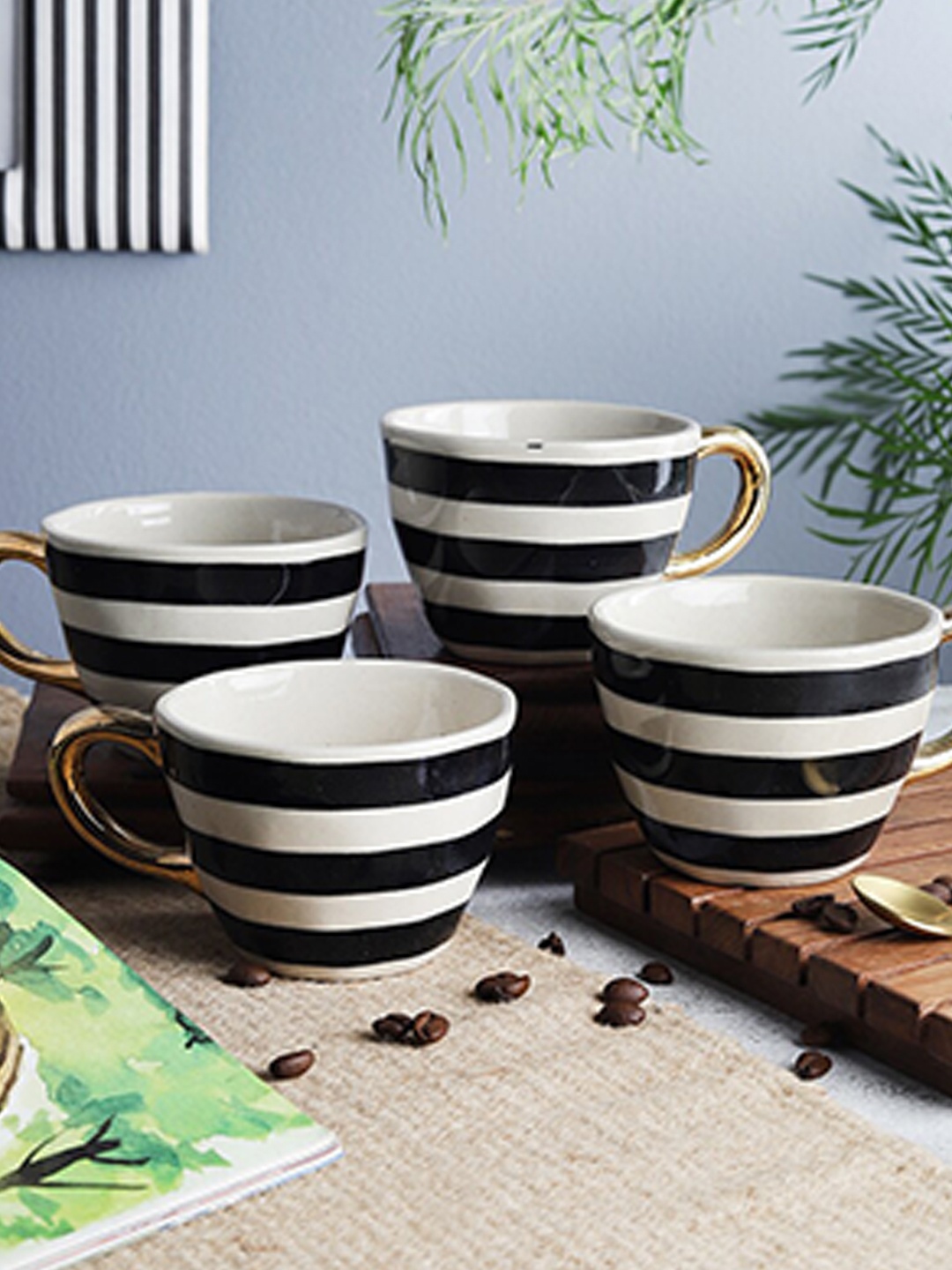 

The Decor Mart Off White & Black Printed 4 Ceramic Glossy Cups Set