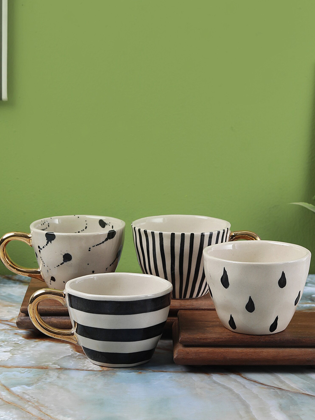 

The Decor Mart Off White & Black Printed 4 Ceramic Glossy Cups Set