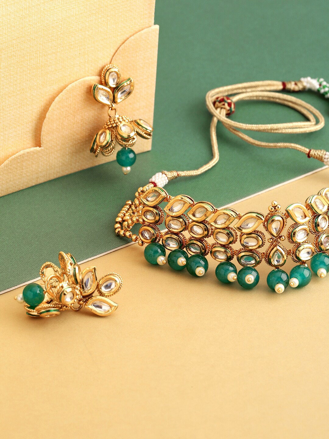

Priyaasi Women Gold-Plated White & Green Kundan-Studded & Beaded Handcrafted Jewellery Set