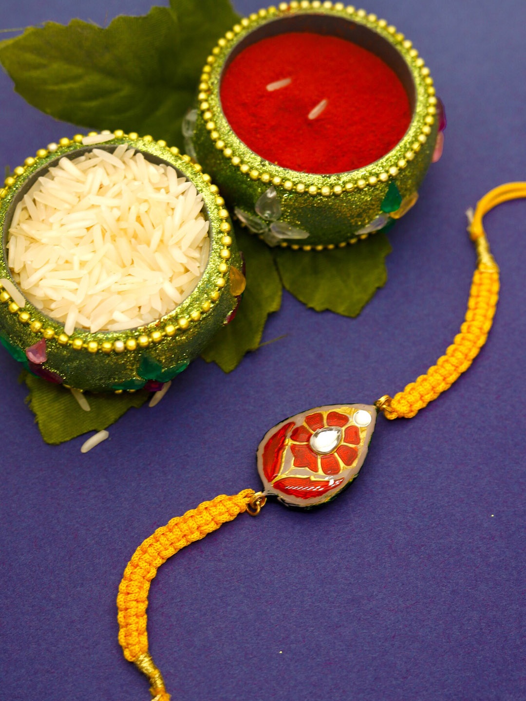 

Shoshaa Orange Kundan Reversible Design Meenakari Rakhi With Roli Chawal