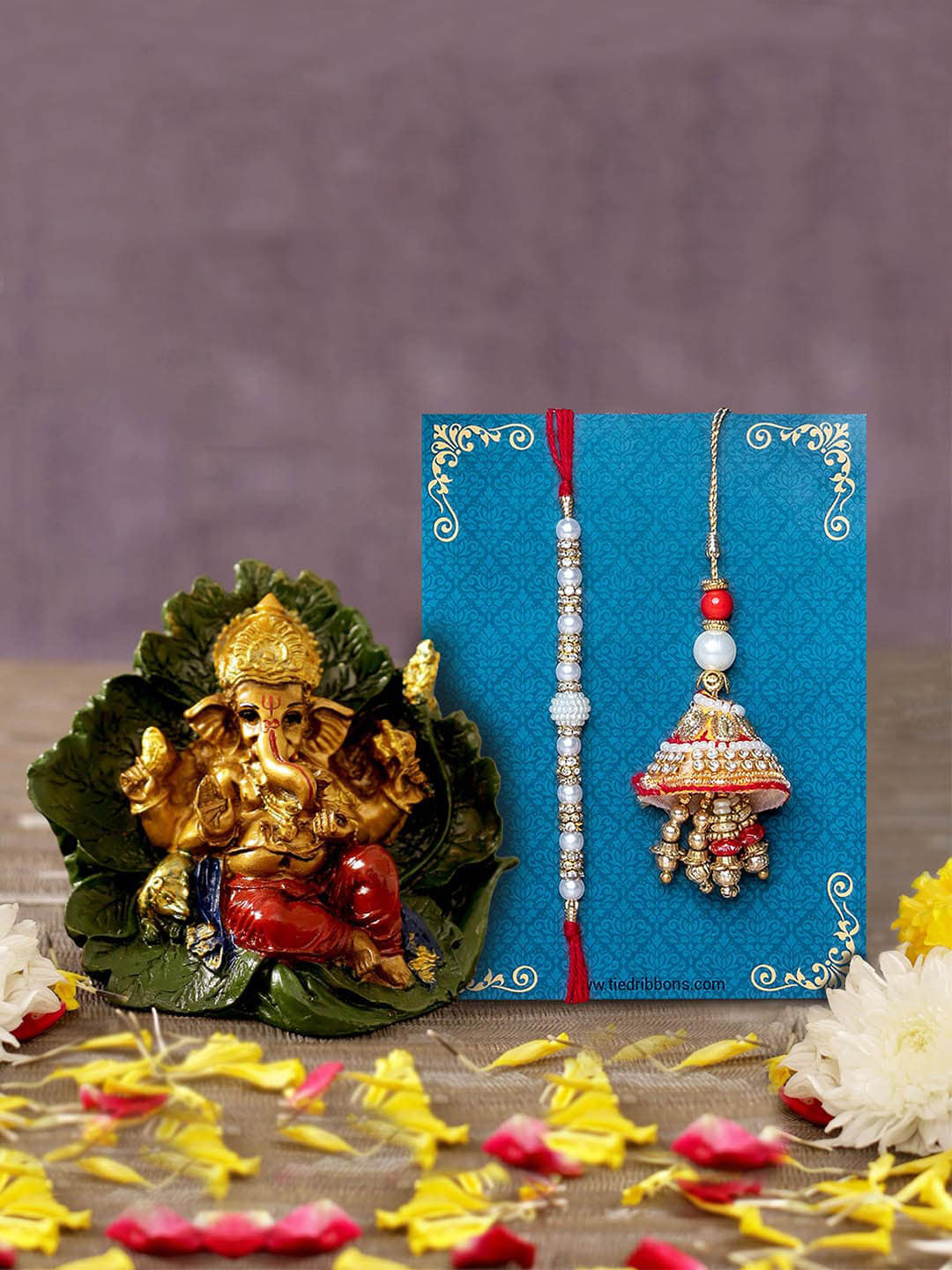 

TIED RIBBONS White & Gold-Toned Bhaiya Bhabhi Lumba Rakhi with Ganesha Idol Combo Gift Set