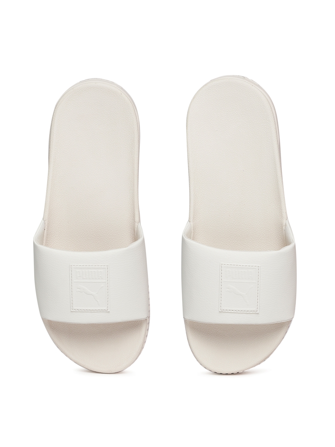 white athletic slides