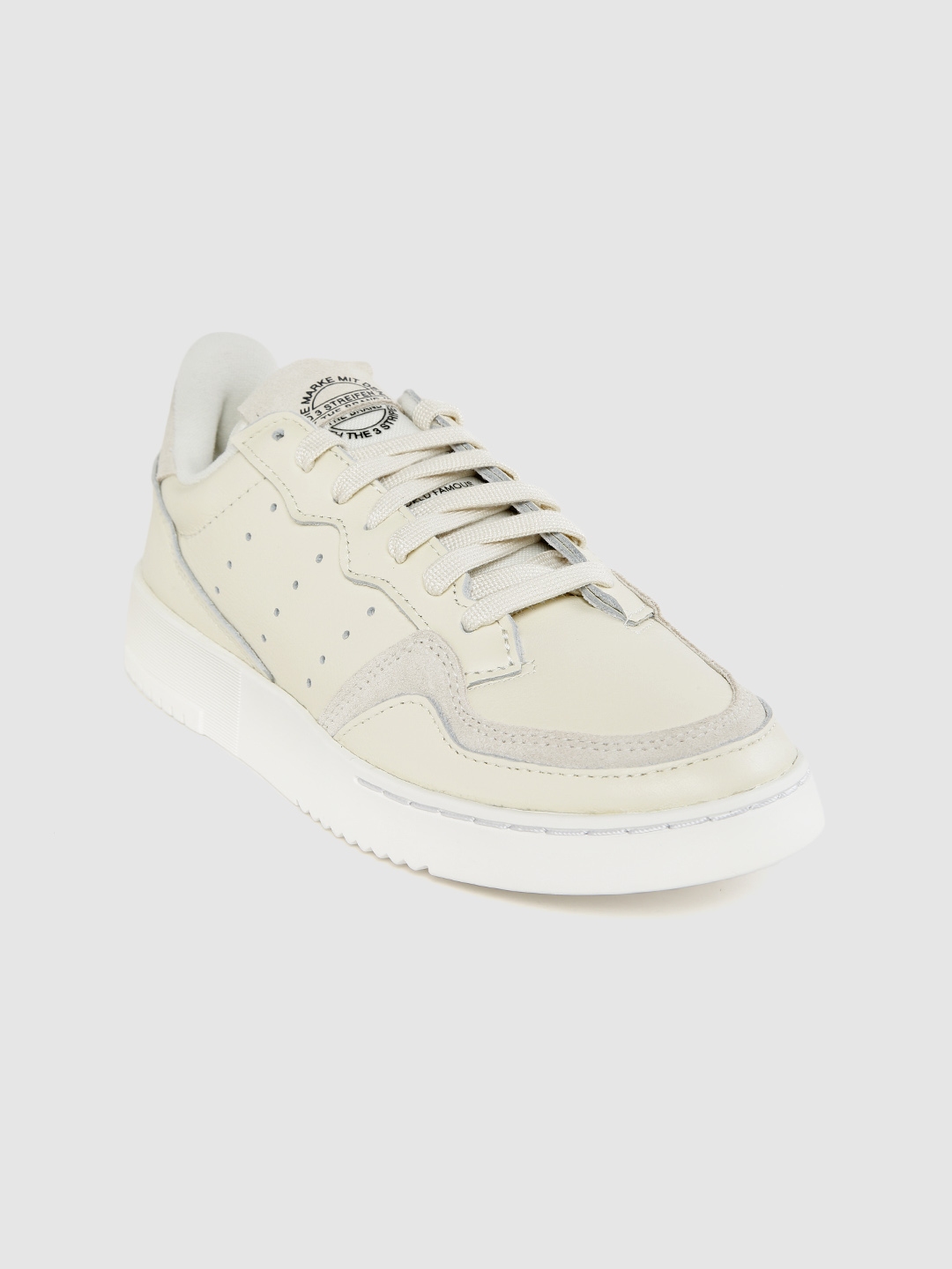 cream colored adidas sneakers
