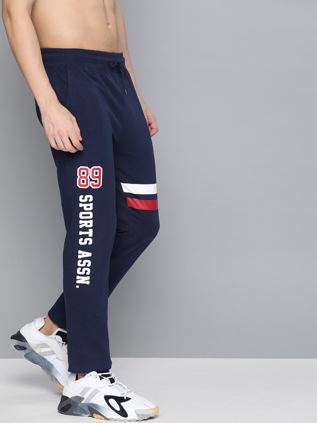 navy blue track pants with red stripe