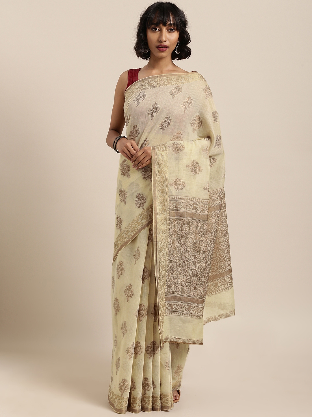 cream and green colour saree