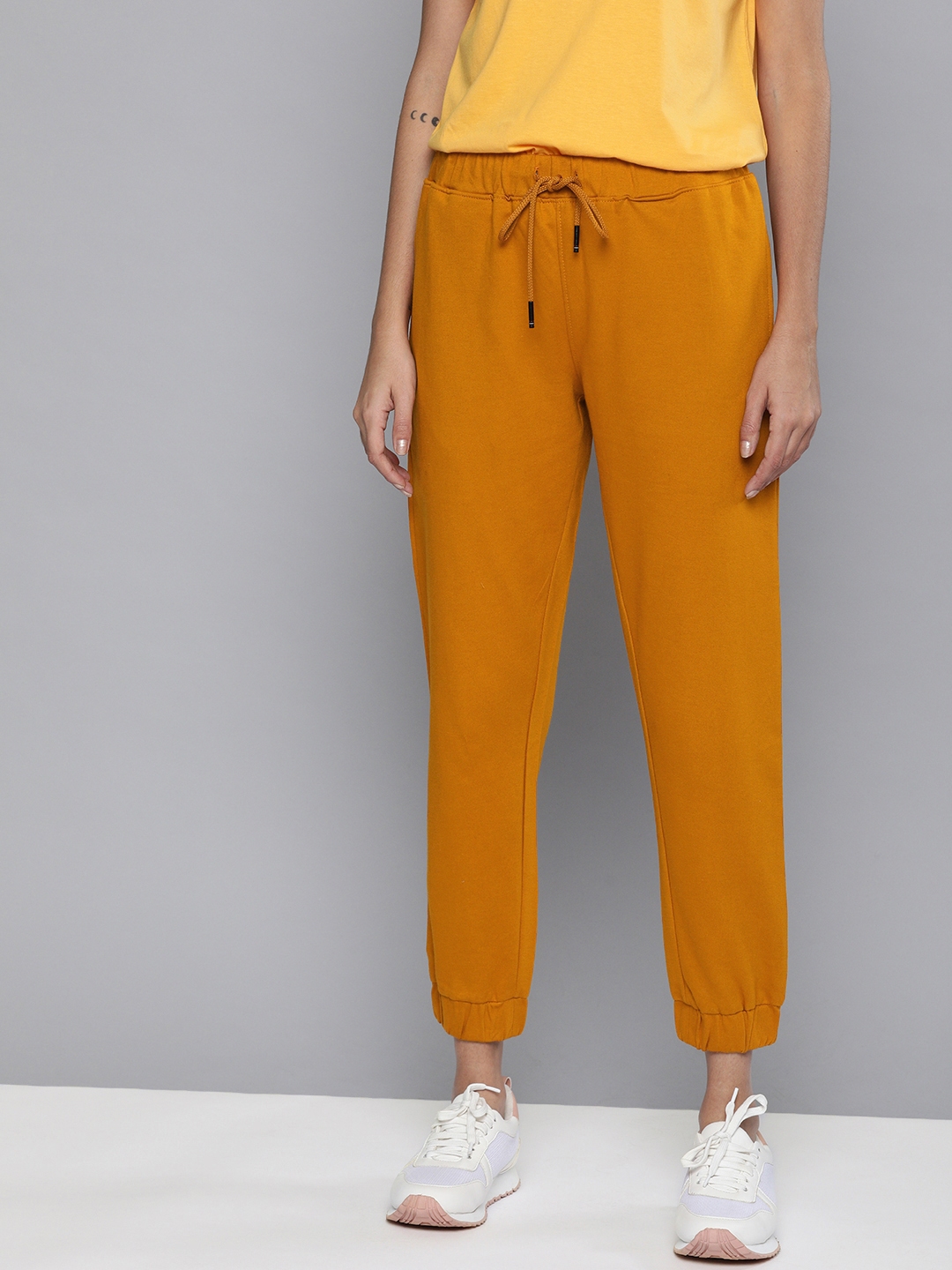 mustard track pants