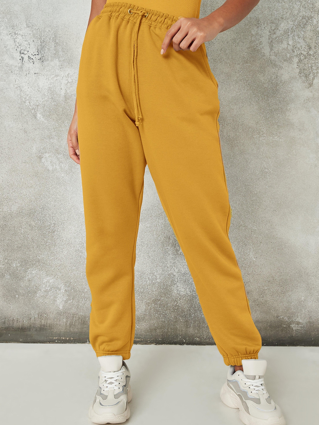 mustard track pants
