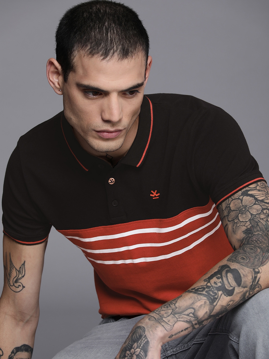 orange shirt with black pants