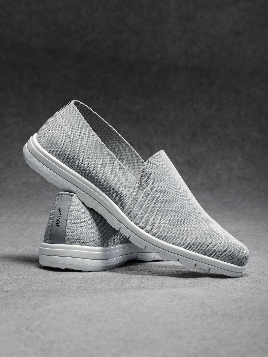black and grey slip ons