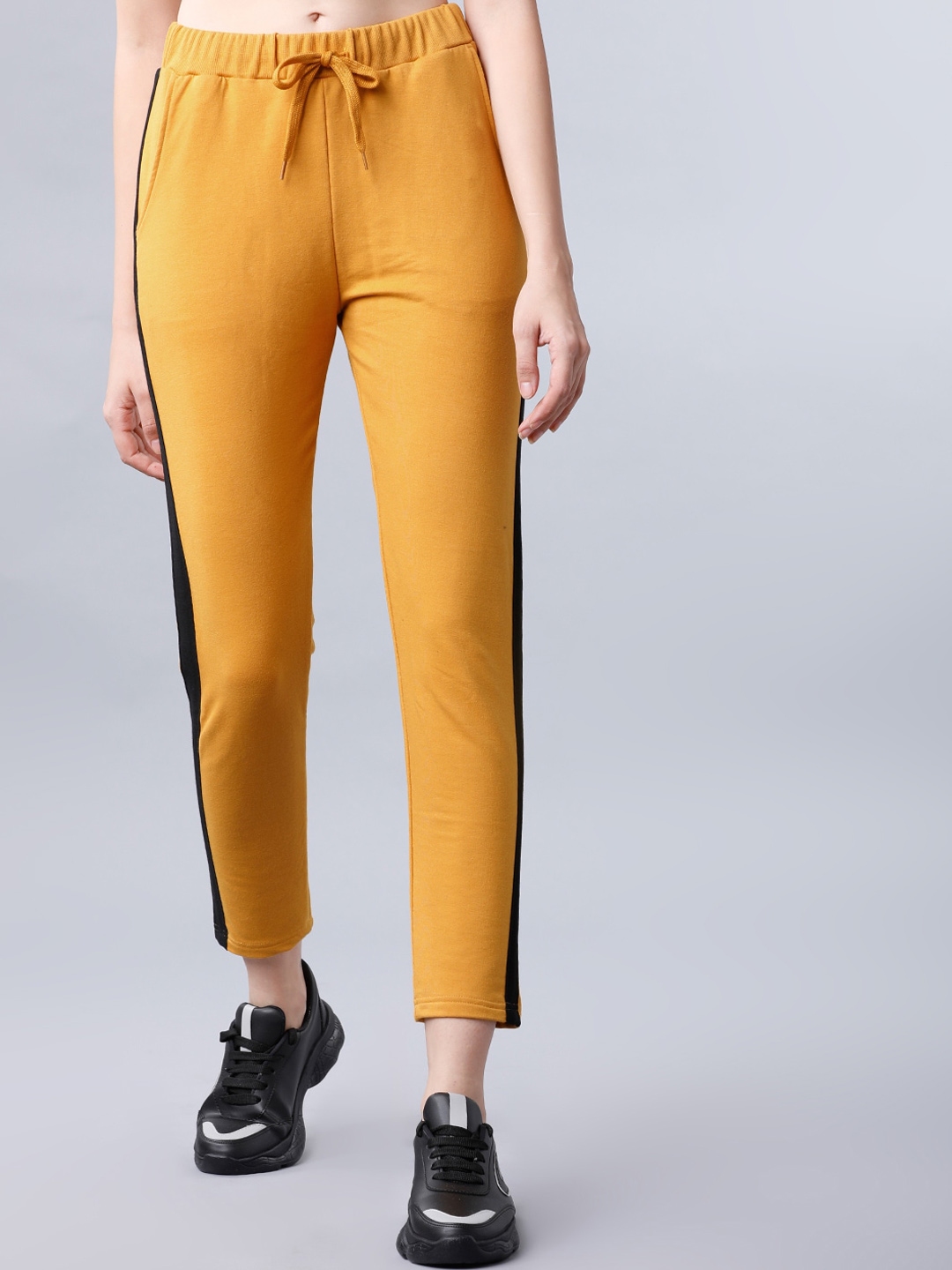 mustard track pants